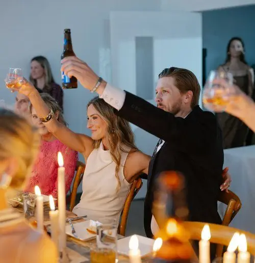 Guests toast during a rehearsal dinner at Hill Country Herb Garden