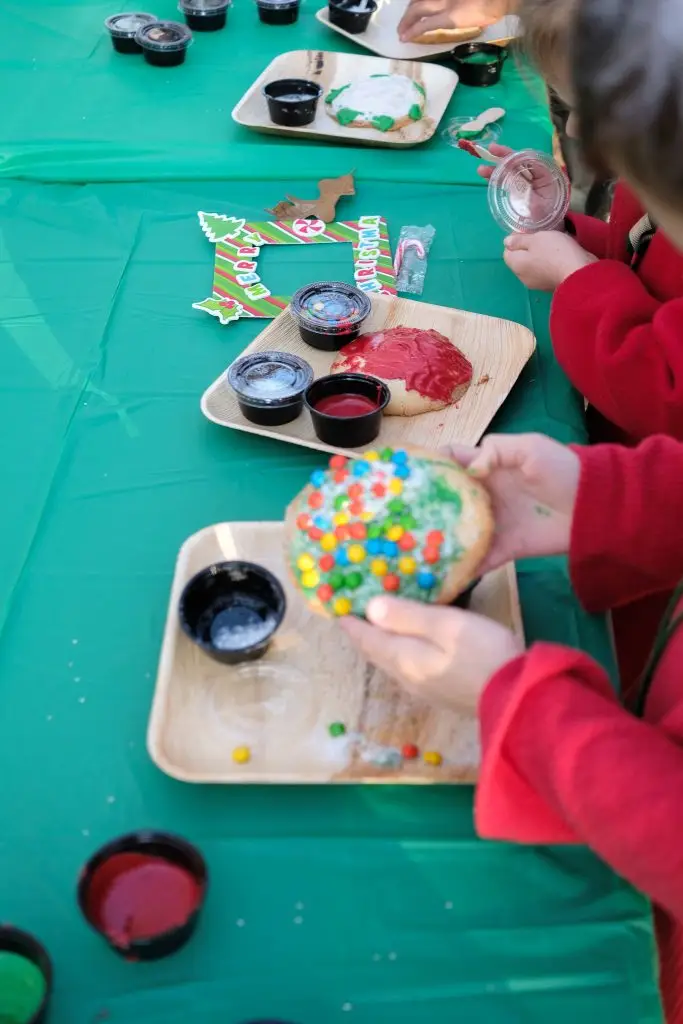 Kids decorating cookies at the Santa in the Garden event in Fredericksburg, Texas
