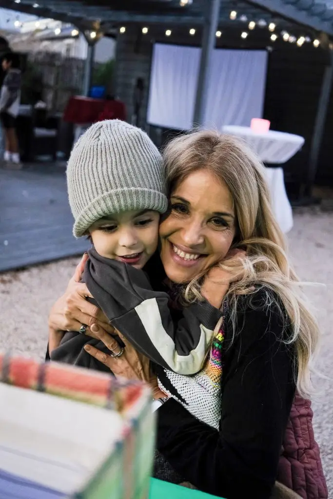 Family hugging at the Santa in the Garden holiday event at the Hill Country Herb Garden