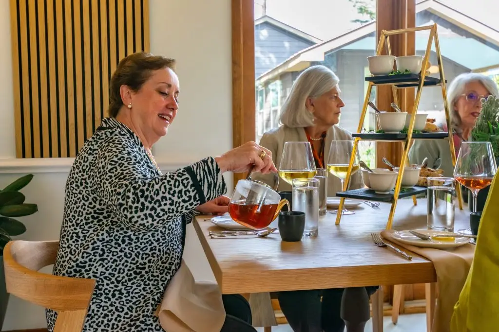 A group of friends gather for tea service at Hill Country Herb Garden.